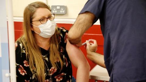 Woman being vaccinated in Sutton