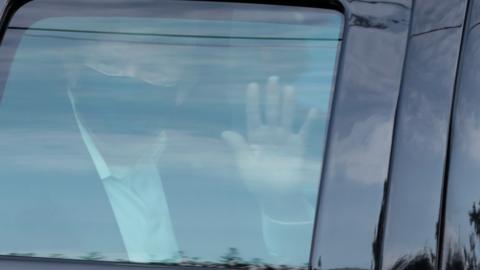 US President Donald Trump rides in front of the Walter Reed National Military Medical Center