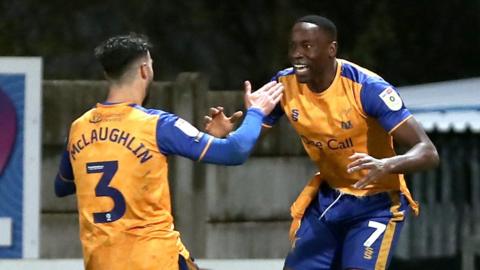 Lucas Akins celebrates his winner for Mansfield against Colchester