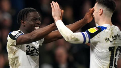 Derby's Festy Ebosele celebrates with Tom Lawrence