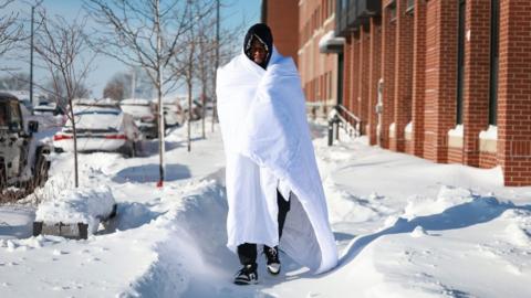 Man wrapped in blanket in Des Moines