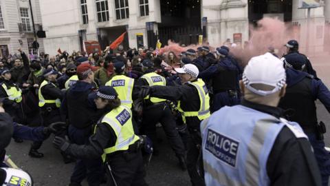 Police trying to control a crowd