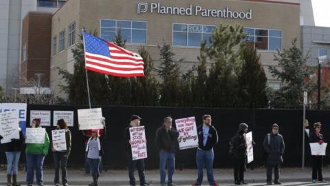 Pro-choice counter-protesters hold signs supporting a woman's right to choose abortion, as nearby anti-abortion activists held a rally in front of Planned Parenthood of the Rocky Mountains, in Denver, Saturday, Feb. 11, 2017.