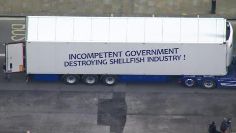 Lorry with protesting slogan about fish trading rules