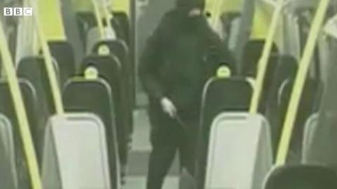 Man holding a knife in train