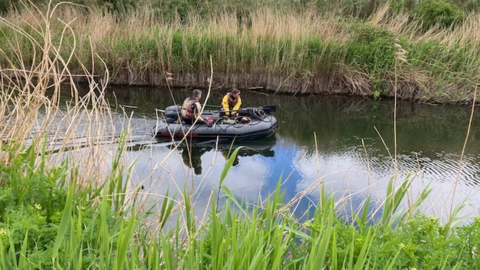 People in a dinghy on the canal