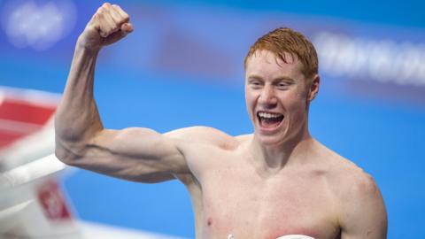 Tom Dean of Great Britain celebrates after victory in the 4x200M relay for Men during the Swimming Finals at the Tokyo Aquatic Centre at the Tokyo 2020 Summer Olympic Games.