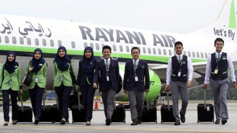 A picture made available on 21 December 2015 shows Rayani Air the Malaysia's first Islamic-compliant airline cabin crew posing for a photograph in front of a Boeing 737-400 at Kuala Lumpur International Airport 2, in Sepang, Malaysia, 20 December 2015