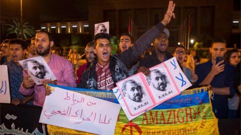 Protesters holding portraits of activist Nasser Zefzafi