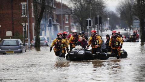 Fire and Rescue teams rescuing people out of flooded homes in Carlisle