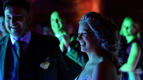 A married couple dance at their wedding