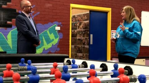 Ian Levy and a youth worker with a football table with blue and red players