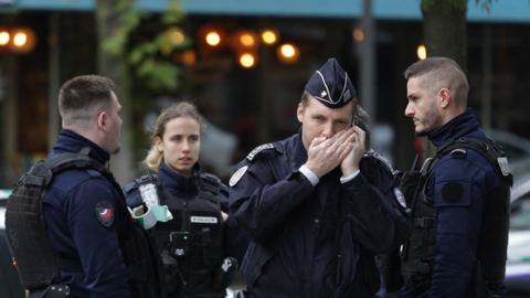 Police officers at the scene of the shooting of a woman in Paris, 31 October