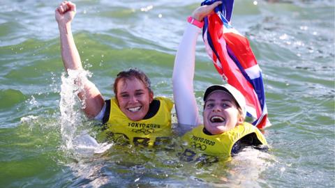 Hannah Mills and Eilidh McIntyre celebrate in the water after jumping in