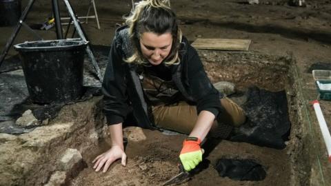 Archaeologist working on the site at Pembroke Castle's Wogan Cavern