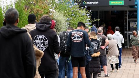 People are seen lining up at Centrelink in Flemington on March 23