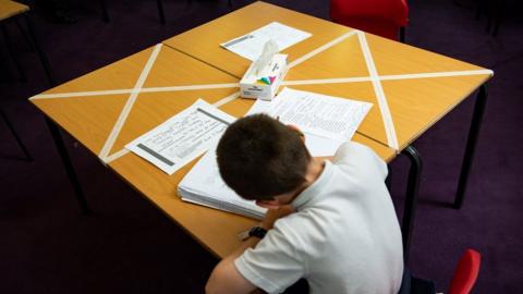 child sits at school desk