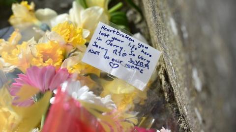 Flowers left at the scene of rioting in Derry when Lyra McKee was shot