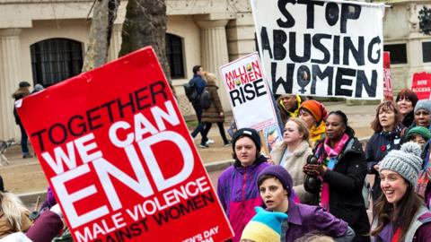 Women hold placards as they take part in Million Women Rise march through central London to New Scotland Yard in a protest demanding an end to male violence against women and children ahead of International Women's Day on 5 March 2022