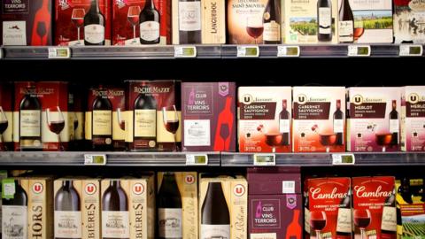 Rows of box wines or cubis, with bag-in-box packaging, are for sale in a supermarket