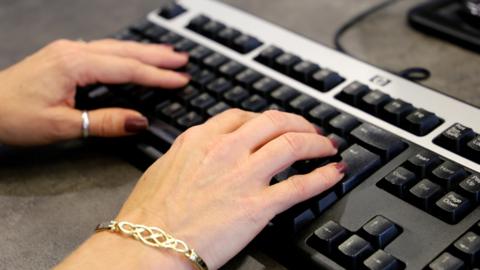 Woman typing on keyboard