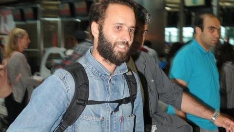 French photographer Mathias Depardon walks at the international departure terminal of Ataturk airport in Istanbul