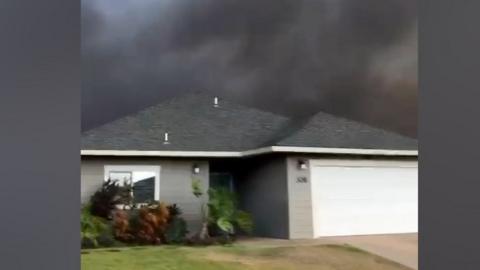 Bungalow in Hawaii with black smoke in the sky