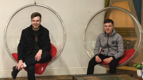 Three staff sitting in circular chairs