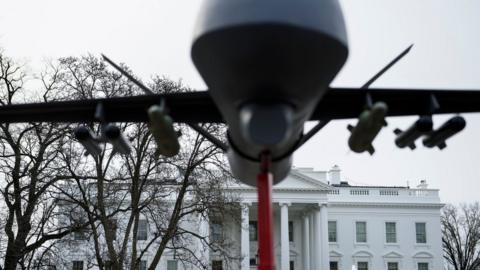 A military drone replica is displayed in front of the White House during a protest against drone strikes