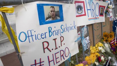 Flowers and signs at a memorial for murdered USCP officer Brian Sicknick, Washington DC, 11 January