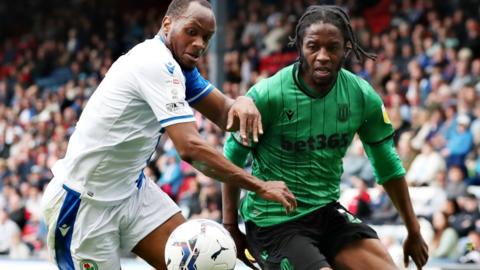 Stoke and Blackburn players challenge for the ball