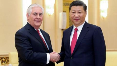 Chinese President Xi Jinping (R) shakes hands with U.S. Secretary of State Rex Tillerson