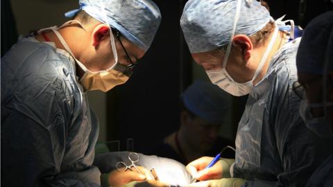 surgeons carry out a transplant