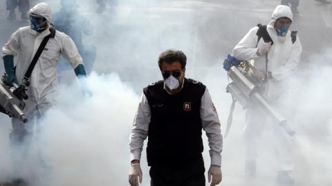 Iranian firefighters disinfect streets in Tehran (13 March 2020)