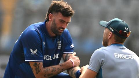 Reece Topley receives treatment on finger injury