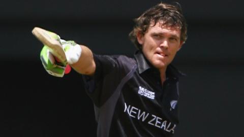 Former New Zealand batter Lou Vincent raises his bat after hitting a century in an ODI
