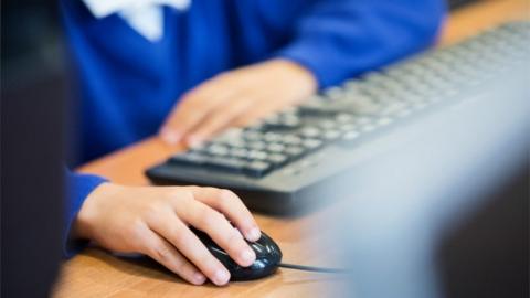 Boy's hand on a computer mouse