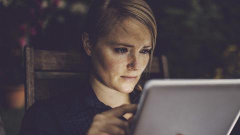 Upset woman using a computer tablet