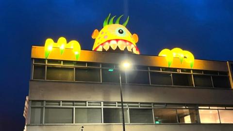 The gigantic creatures are lurking over Lincoln's rooftops for Halloween