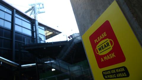 A notice advising fans to wear a face mask is seen prior to the Championship match between Watford and Cardiff City