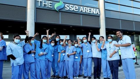 Vaccine staff outside the SSE Arena in Belfast