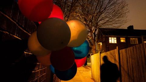 Balloons in an alleyway