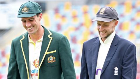 Australia's Test captain Pat Cummins laughs with England's captain Joe Root