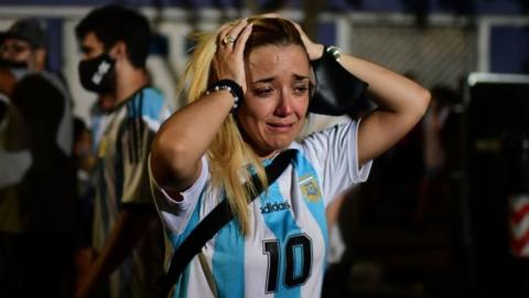 A fan of Argentinian football legend Diego Maradona cries