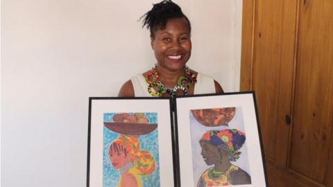 Joanne Howell holding art work