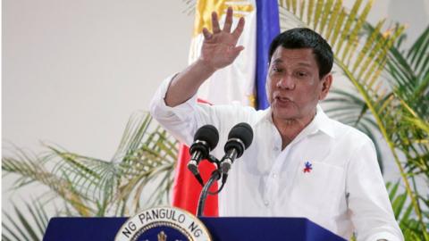 Philippine President Rodrigo Duterte gestures while answering questions during a news conference upon his arrival from a state visit in Japan at the Davao International Airport in Davao city, Philippines October 27, 2016.