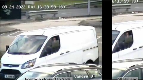 A picture of white van with a driver in the front seat