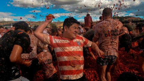 People participate in the tenth annual tomato fight festival, known as "Tomatina", in Sutamarchan, Boyaca department, Colombia, on 2 June 2019.