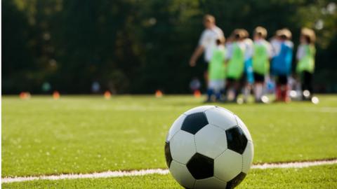 Children in football lesson