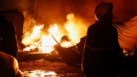 A firefighter gathers at the scene of an explosion at a makeshift gas cylinder refilling depot in Mradi estate, Embakasi district of Nairobi